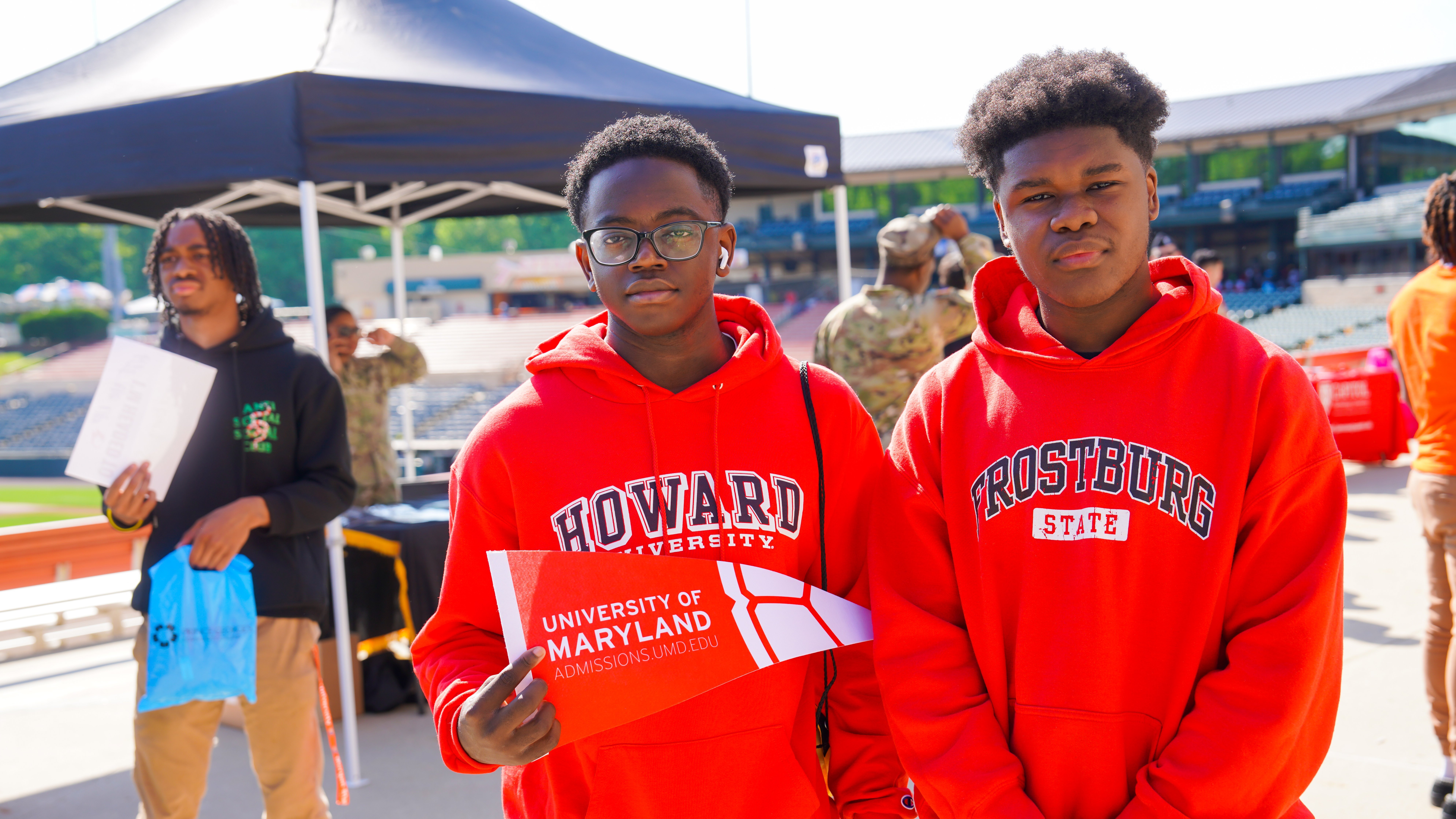 Two Students Wearing College Merch.jpg