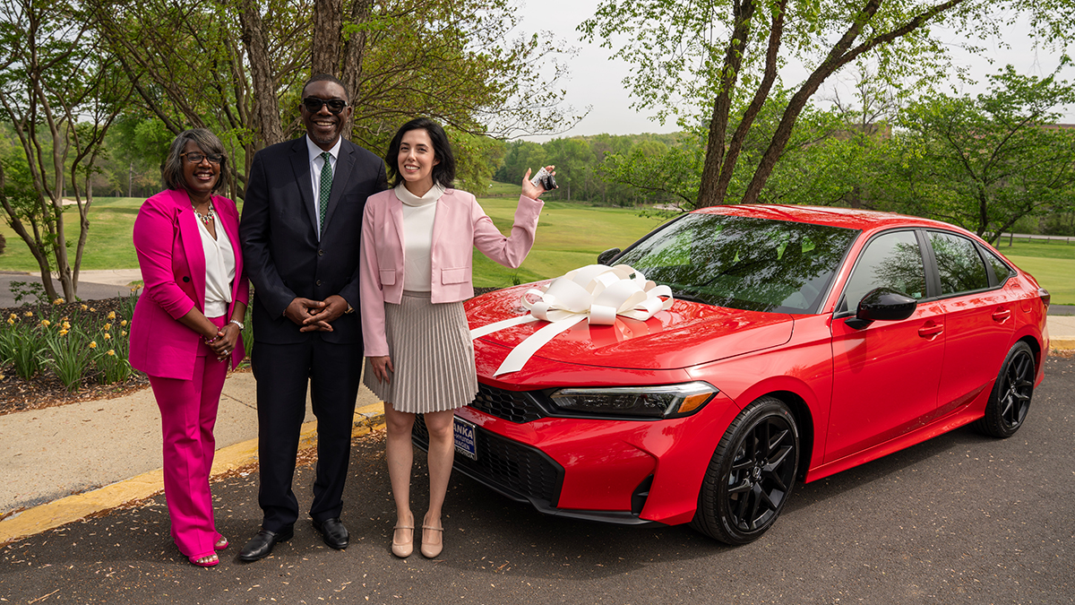Clara-Allsup-teacher-of-year-with-car-Dr-Joseph