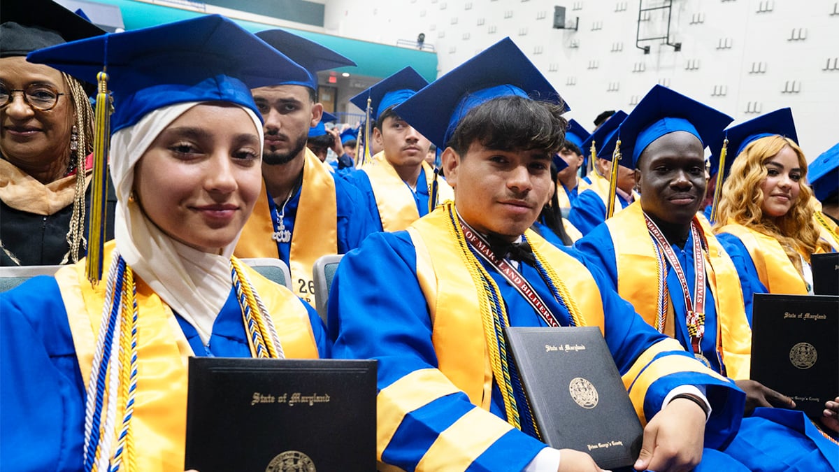 International-High-School-at-Langley-Park-graduates-holding-diplomas