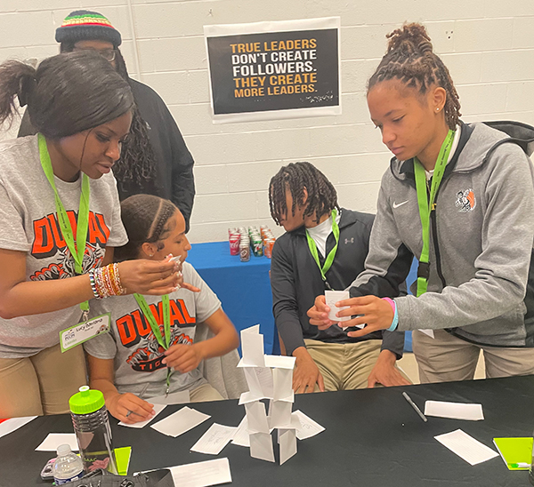 DuVal students building card tower