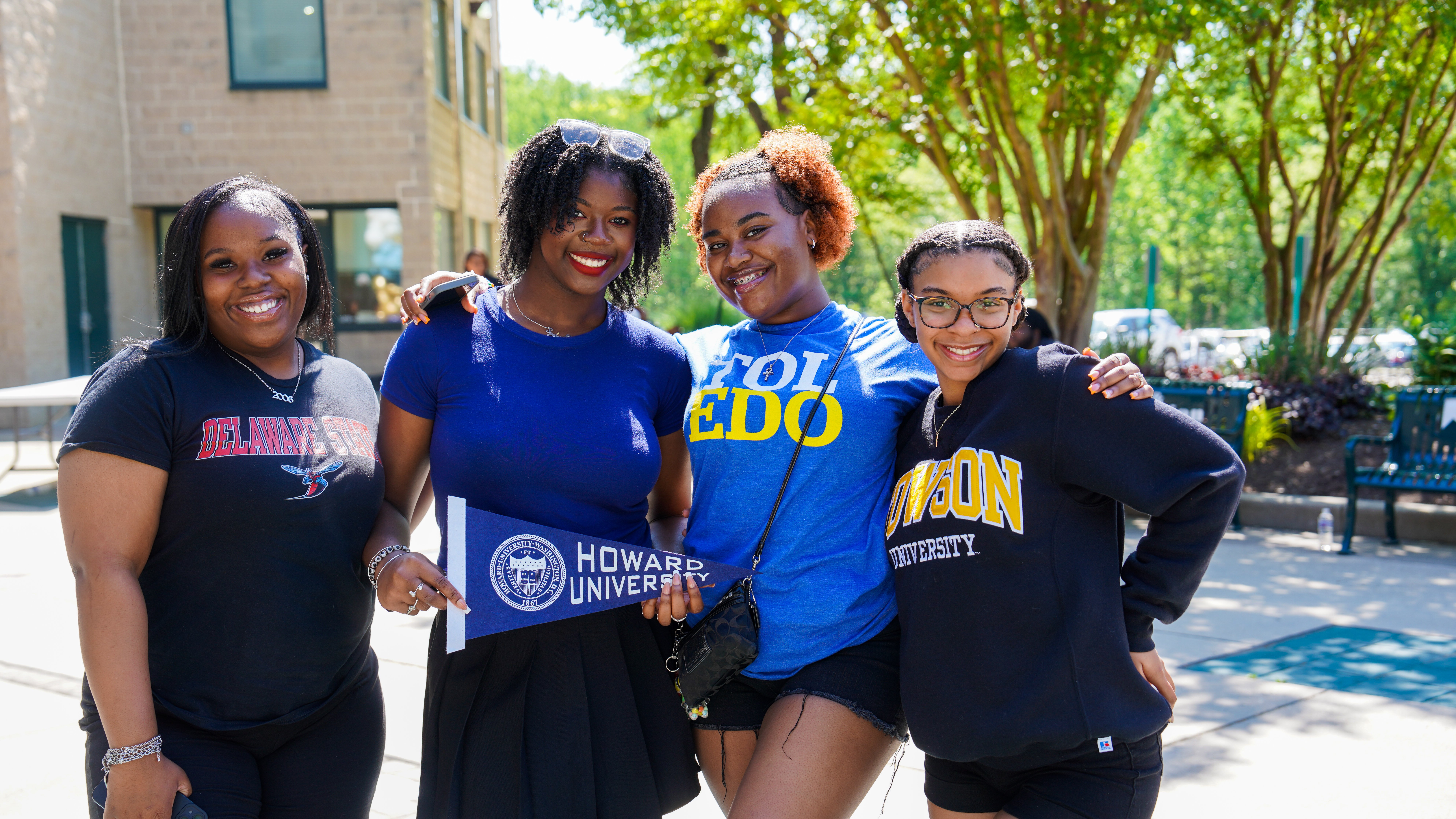 Four Women Students With College Merch.jpg