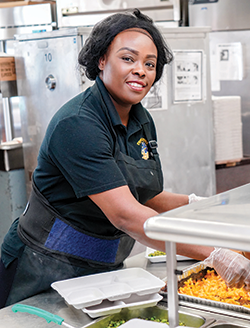 Smiling Cafeteria Worker.png