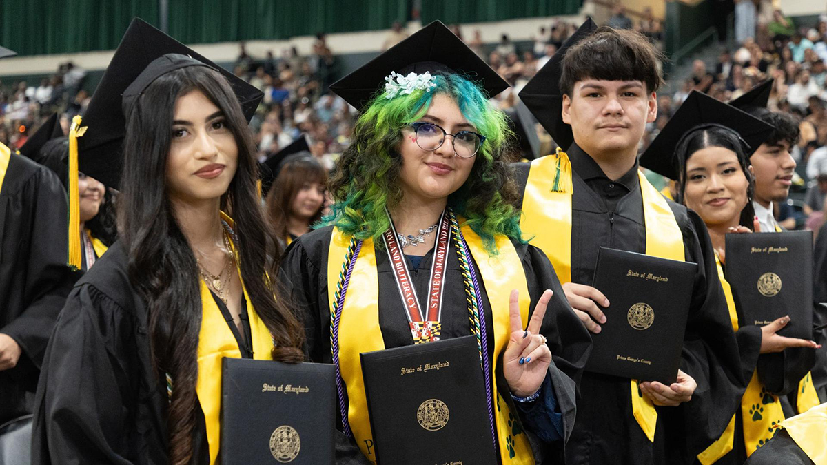 Parkdale graduates holding diplomas