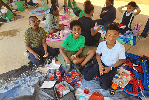 students eating lunch outside in group