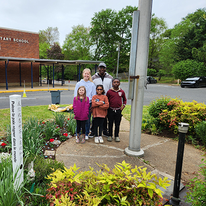 PD-adults-students-near-flagpole.jpg