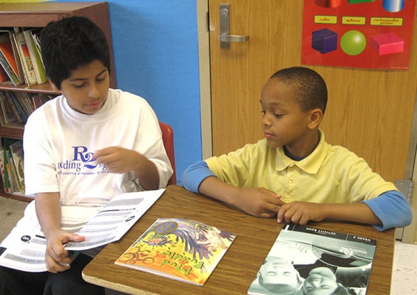 RELA-male-students-reading-a-book-in-class.jpg