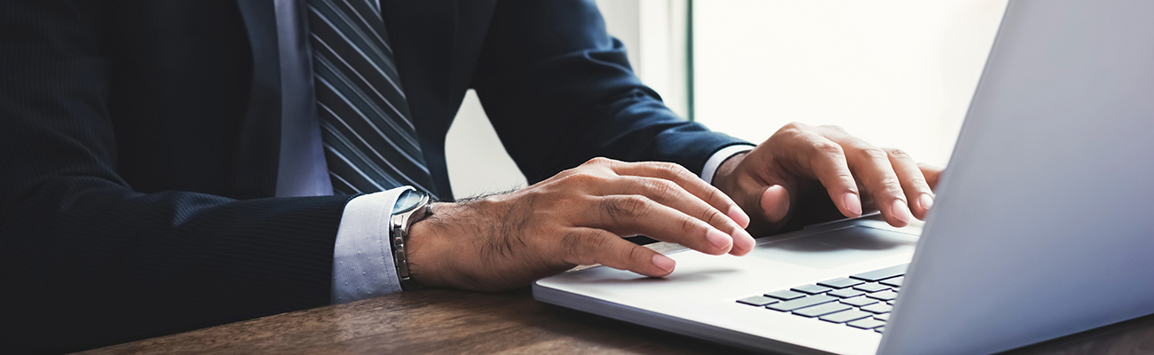 Man in suit at computer 