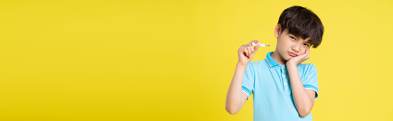 sick-boy-holding-thermometer