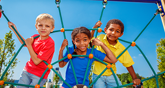 elementary students on playground equipment